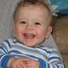 His first tooth! And that hair got longer and curlier!
